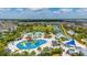 Aerial view of a water park featuring colorful slides and pools surrounded by lush landscaping and community homes at 420 Burma St, Kissimmee, FL 34747