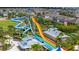 A set of tall, colorful water slides provides thrilling aquatic adventure, towering over an inviting community at 420 Burma St, Kissimmee, FL 34747