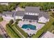 Beautiful aerial view of landscaped home with pool, patio, and well-maintained yard at 423 Arbor Cir, Celebration, FL 34747