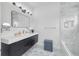 Modern bathroom features a floating vanity, stylish mirror, elegant fixtures, and walk-in shower with sleek tile at 423 Arbor Cir, Celebration, FL 34747