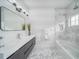 Bright bathroom featuring a sleek vanity, modern fixtures, a framed mirror, and a glass-enclosed shower at 423 Arbor Cir, Celebration, FL 34747