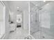 Luxurious bathroom with marble flooring, shower, and a glimpse into an adjacent room, offering a spa-like experience at 423 Arbor Cir, Celebration, FL 34747