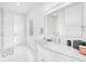 Bright bathroom features a marble countertop vanity and stylish mirror, complemented by modern fixtures and ample lighting at 423 Arbor Cir, Celebration, FL 34747
