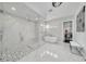 The bathroom has a large shower, a free standing tub, marble walls, and custom tile work at 423 Arbor Cir, Celebration, FL 34747