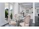 This dining area has a small table with four chairs looking into the kitchen and out to the yard at 423 Arbor Cir, Celebration, FL 34747