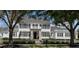 Charming two-story white home with black shutters and manicured landscaping offers timeless curb appeal at 423 Arbor Cir, Celebration, FL 34747
