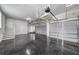 Large garage with epoxy floors, storage racks, and multiple garage door bays at 423 Arbor Cir, Celebration, FL 34747