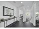 Bright hallway featuring dark wood floors and a view into the main bedroom at 423 Arbor Cir, Celebration, FL 34747