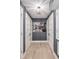 Hallway featuring a photo of a red bus, multiple doors, and neutral wood floors at 423 Arbor Cir, Celebration, FL 34747