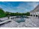 Inviting backyard with a pristine pool, comfortable lounge seating, and lush greenery at 423 Arbor Cir, Celebration, FL 34747