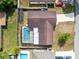 Aerial view of a home featuring a screened-in pool, fenced yard, and a well-maintained roof at 4412 Mesa Verde Dr, St Cloud, FL 34769