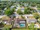 High angle aerial view of houses in a neighborhood surrounded by big trees and a lake at 4412 Mesa Verde Dr, St Cloud, FL 34769