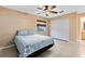 Neutral bedroom with tile floors, ceiling fan, and a window for natural light at 4412 Mesa Verde Dr, St Cloud, FL 34769