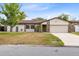 Charming single-story home with a well-manicured lawn, stone accents, and a two-car garage at 4412 Mesa Verde Dr, St Cloud, FL 34769