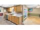 Bright kitchen with stainless steel appliances, light cabinets, and view into the living room at 4412 Mesa Verde Dr, St Cloud, FL 34769