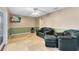 Comfortable living room featuring tile floors, ceiling fan, and stylish green and beige paint at 4412 Mesa Verde Dr, St Cloud, FL 34769