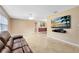 Spacious living room featuring tile floors, a ceiling fan, and a mounted television at 4412 Mesa Verde Dr, St Cloud, FL 34769