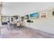 Covered patio with a dining table, chairs, two TVs, and a fan for outdoor entertainment at 4412 Mesa Verde Dr, St Cloud, FL 34769