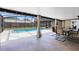 Screened-in pool area featuring a covered patio with dining furniture and curtains for added privacy at 4412 Mesa Verde Dr, St Cloud, FL 34769
