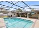 Inviting pool with screened enclosure, featuring a covered patio area for relaxation and entertainment at 4412 Mesa Verde Dr, St Cloud, FL 34769