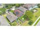 Aerial view of a suburban home with solar panels, green lawn, and fenced backyard garden at 5114 Olde Kerry Dr, Orlando, FL 32837