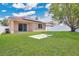 Expansive backyard with lush lawn, mature trees, and patio, perfect for outdoor gatherings at 5114 Olde Kerry Dr, Orlando, FL 32837