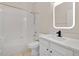 Bright bathroom featuring a shower-tub combo, a white vanity with a black faucet, and a square backlit mirror at 5114 Olde Kerry Dr, Orlando, FL 32837