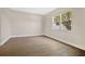 Bright and airy bedroom with wood-look floors and a large window at 5114 Olde Kerry Dr, Orlando, FL 32837