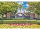 Entrance to Westshire neighborhood featuring a brick sign with lush landscaping at 5114 Olde Kerry Dr, Orlando, FL 32837