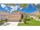 Charming single-story home with manicured lawn, mature trees, and a two-car garage at 5114 Olde Kerry Dr, Orlando, FL 32837