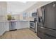 Well-equipped kitchen with stainless steel appliances, dishwasher, and ample countertop space at 5114 Olde Kerry Dr, Orlando, FL 32837
