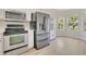 Modern kitchen featuring stainless steel appliances, white cabinetry, and plenty of natural light at 5114 Olde Kerry Dr, Orlando, FL 32837