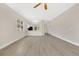 Spacious open-concept room with wood-look floors and a view of the kitchen at 5114 Olde Kerry Dr, Orlando, FL 32837