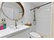 Bathroom featuring a modern sink, round mirror, and walk-in shower, offering a stylish and functional space at 5234 Eaglesmere Dr # D04, Orlando, FL 32819