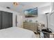 Bedroom with a large wall-mounted TV and silver dresser providing both entertainment and storage at 5234 Eaglesmere Dr # D04, Orlando, FL 32819