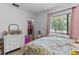 Bright bedroom with a closet, a large window and a floral-patterned bedspread, creating a cozy and inviting space at 5234 Eaglesmere Dr # D04, Orlando, FL 32819