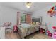 Charming bedroom featuring a floral bedspread, a vanity table, creating a delightful and playful atmosphere at 5234 Eaglesmere Dr # D04, Orlando, FL 32819