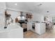 Open kitchen with white cabinets, a center island, stainless steel appliances, and a view of the adjacent dining area at 5234 Eaglesmere Dr # D04, Orlando, FL 32819
