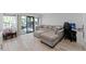 Spacious living room featuring a large sectional sofa, sliding glass doors, and an adjacent play area at 5234 Eaglesmere Dr # D04, Orlando, FL 32819