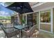 Outdoor patio with a glass table and four chairs, providing a relaxing space under a large umbrella at 5234 Eaglesmere Dr # D04, Orlando, FL 32819