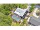 Aerial view of home showcasing screened pool enclosure and mature tropical landscaping at 5234 Ohio St, Winter Park, FL 32792