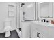 Bathroom features a modern vanity, glass shower, and black hexagon tile flooring at 5234 Ohio St, Winter Park, FL 32792