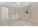 Minimalist bedroom featuring two windows for natural light, tile flooring, and closet at 5234 Ohio St, Winter Park, FL 32792