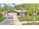 Charming single-story home with a lush front yard and mature palm trees at 5234 Ohio St, Winter Park, FL 32792