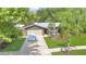 Welcoming home with a two-car garage, lush lawn, and mature palm trees in the front yard at 5234 Ohio St, Winter Park, FL 32792