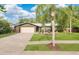 Charming home with a well-manicured lawn and mature palm trees, offering great curb appeal at 5234 Ohio St, Winter Park, FL 32792