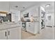 Modern kitchen featuring white cabinets, stainless steel appliances, and bright countertops at 5234 Ohio St, Winter Park, FL 32792