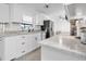 Well-lit kitchen with stainless steel appliances, updated cabinets, and tiled flooring at 5234 Ohio St, Winter Park, FL 32792