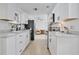 Bright kitchen featuring white cabinets, stainless steel appliances, and ample counter space at 5234 Ohio St, Winter Park, FL 32792