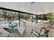 Covered patio with brick flooring and view of the pool and backyard at 5234 Ohio St, Winter Park, FL 32792